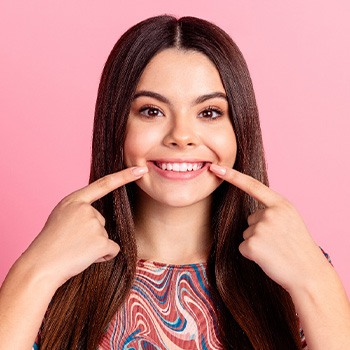 Woman pointing to her teeth