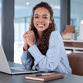 Woman smiling while working in office